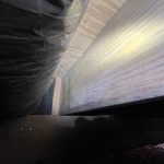 Encapsulated crawl space in Nineveh, IN showing treated wooden joists after mold remediation and moisture control work.