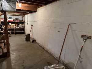 Interior view of a concrete block basement foundation wall in need of structural inspection in Indianapolis.